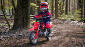 A young rider on trail riding a CRF50F