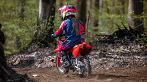 A young rider on trail riding a CRF50F